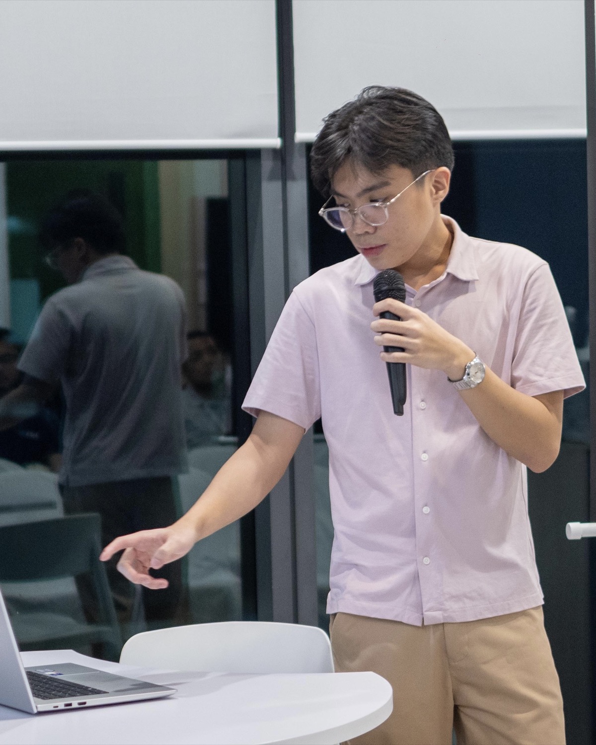 Mark Macaraeg presenting beside a laptop